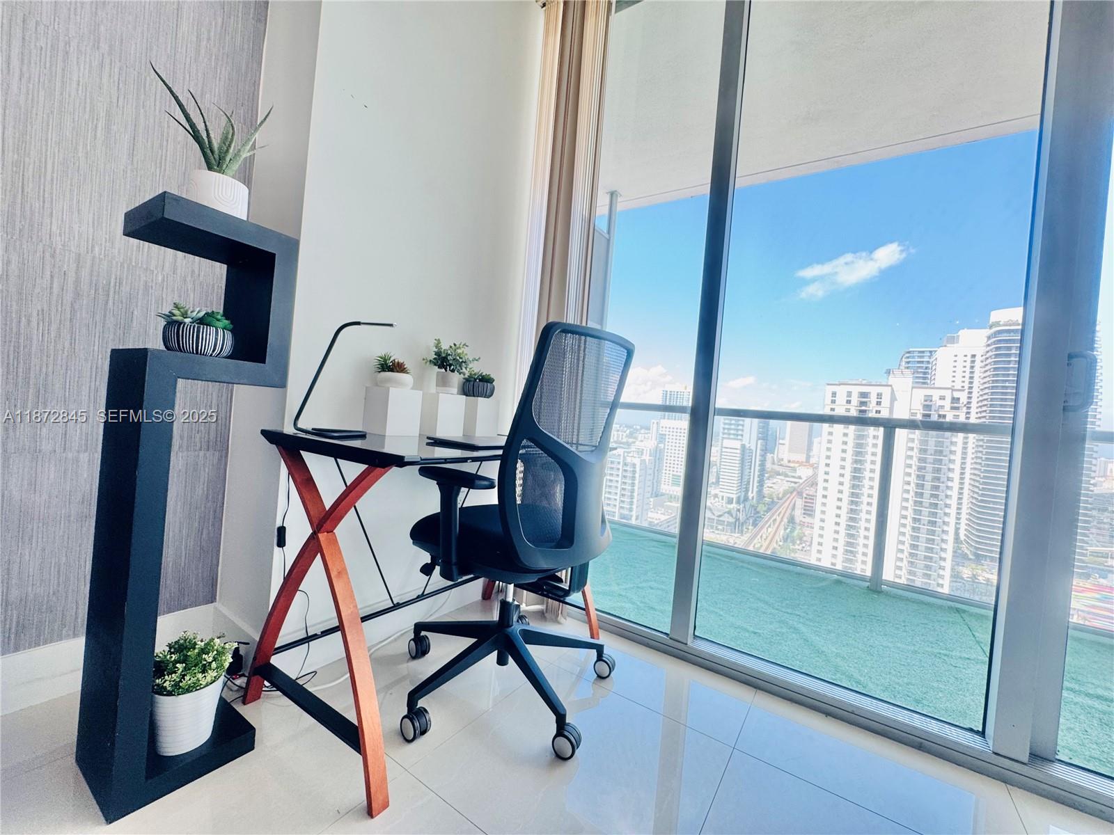 79 Southwest 12th Street, Unit 3211S Miami, FL 33130 - Photo 11 of 32 a work room with furniture and potted plants
