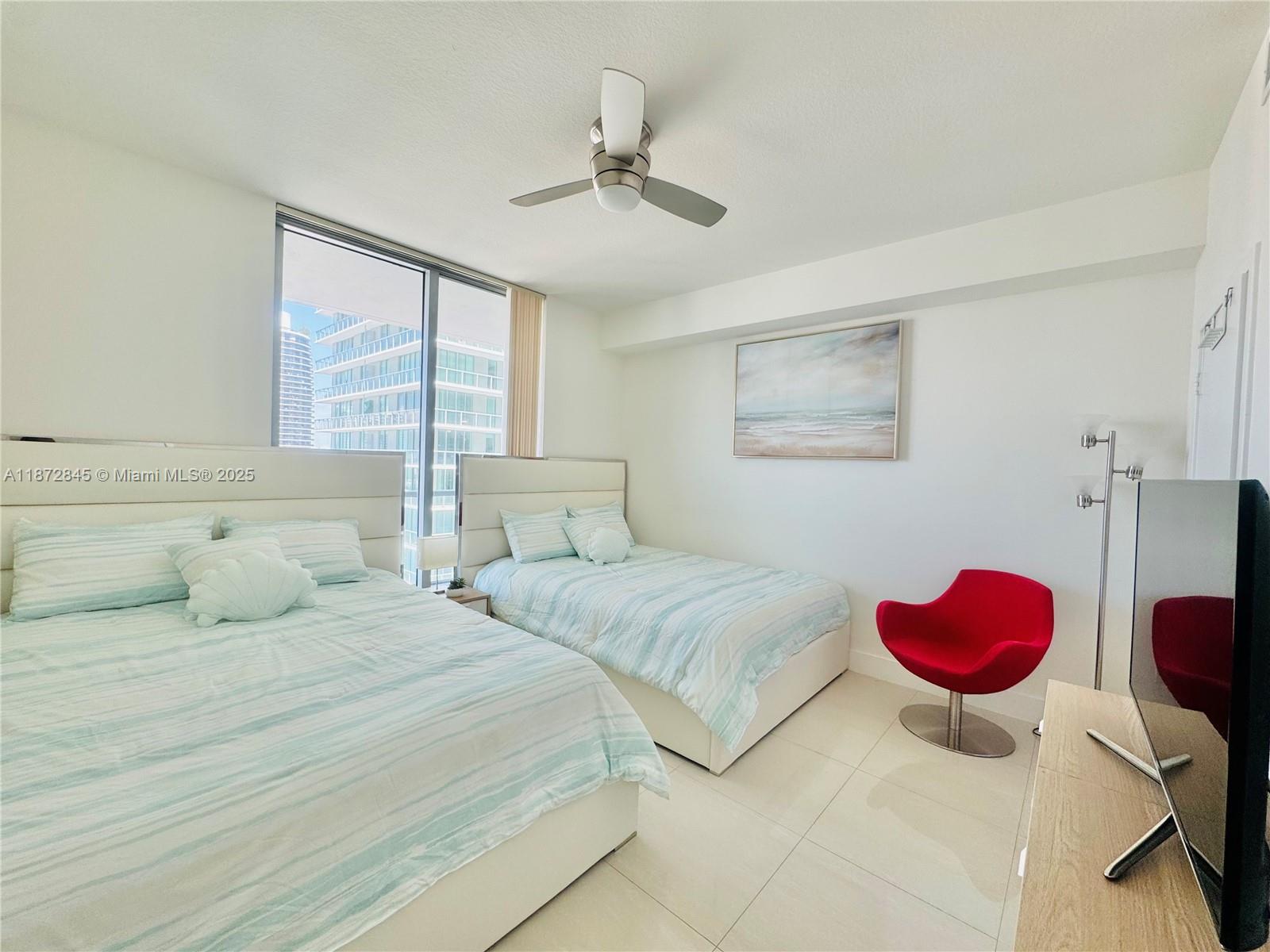 79 Southwest 12th Street, Unit 3211S Miami, FL 33130 - Photo 13 of 32 a bedroom with two beds and potted plant