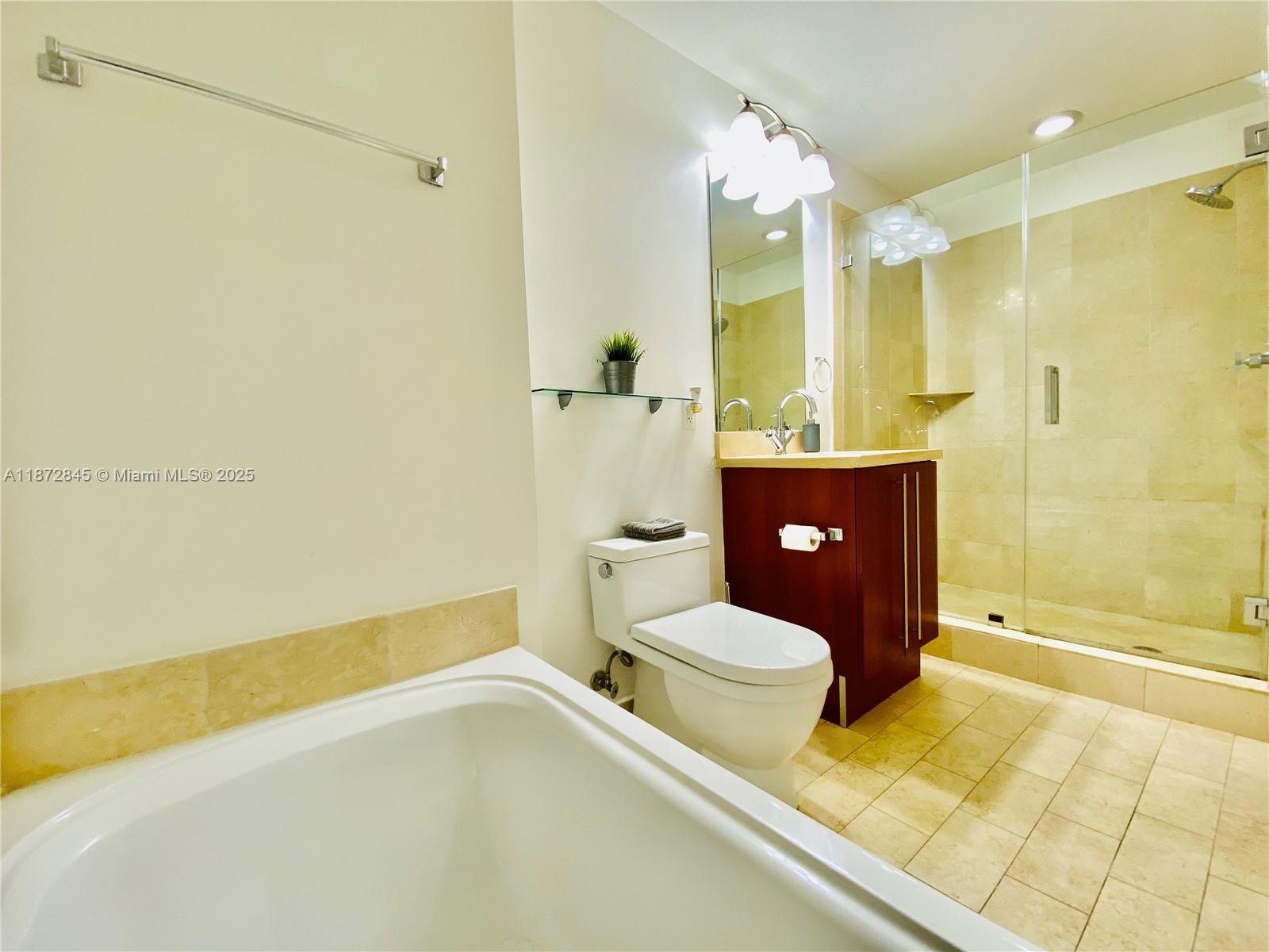 79 Southwest 12th Street, Unit 3211S Miami, FL 33130 - Photo 14 of 32 a bathroom with a toilet and a shower
