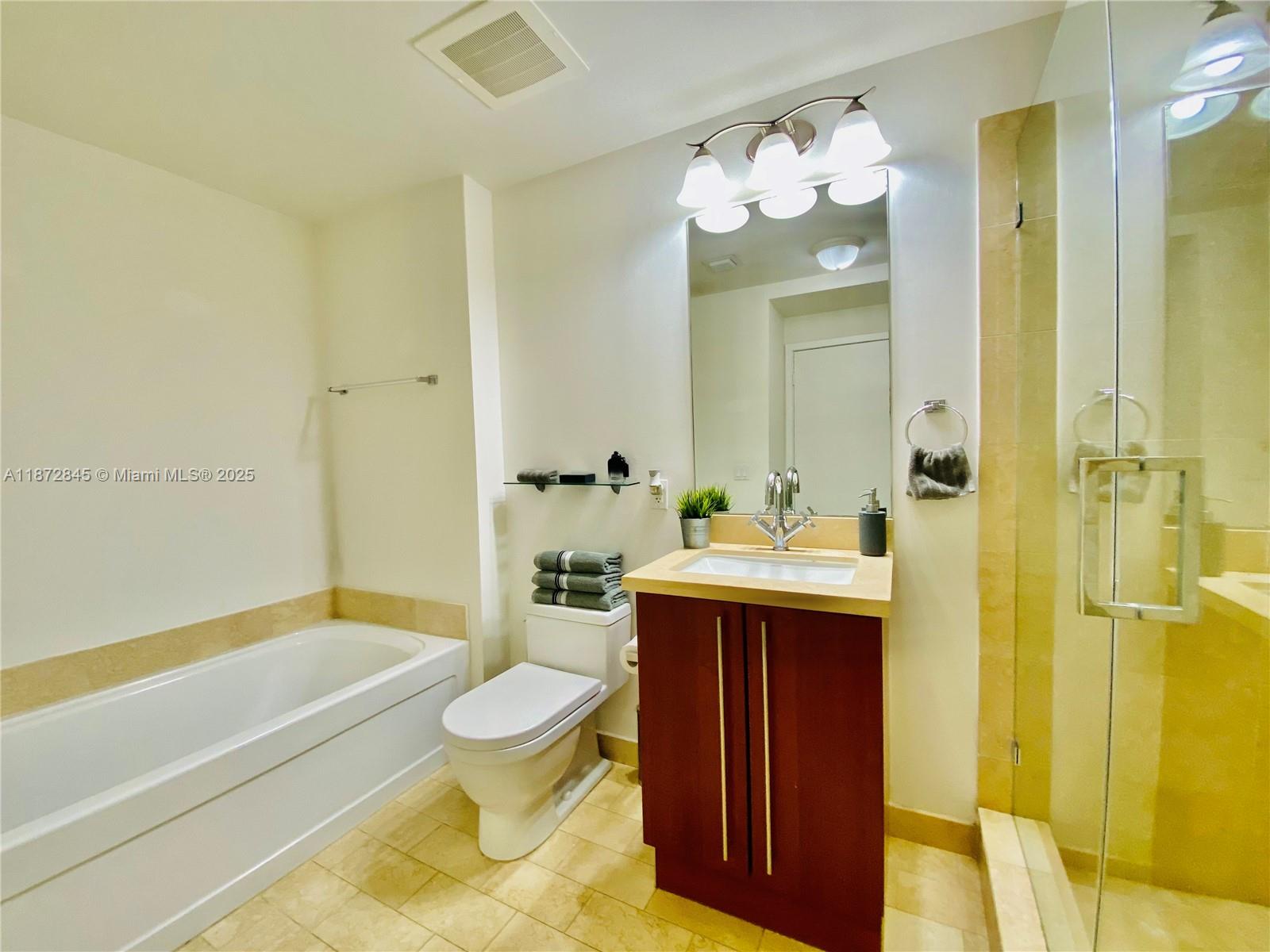 79 Southwest 12th Street, Unit 3211S Miami, FL 33130 - Photo 15 of 32 a bathroom with a sink a toilet and shower
