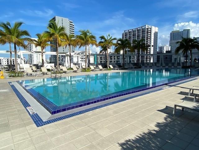 79 Southwest 12th Street, Unit 3211S Miami, FL 33130 - Photo 21 of 32 a view of a swimming pool with a lounge chairs