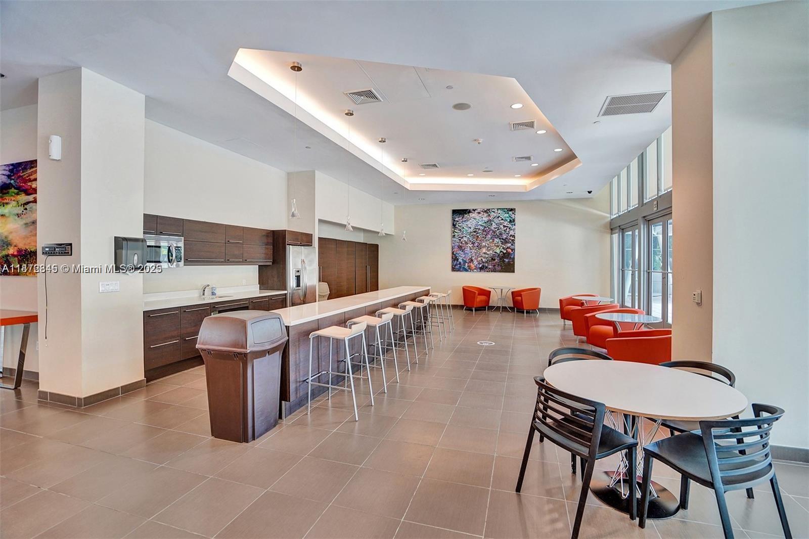 79 Southwest 12th Street, Unit 3211S Miami, FL 33130 - Photo 24 of 32 a room with stainless steel appliances kitchen island granite countertop furniture and a kitchen view