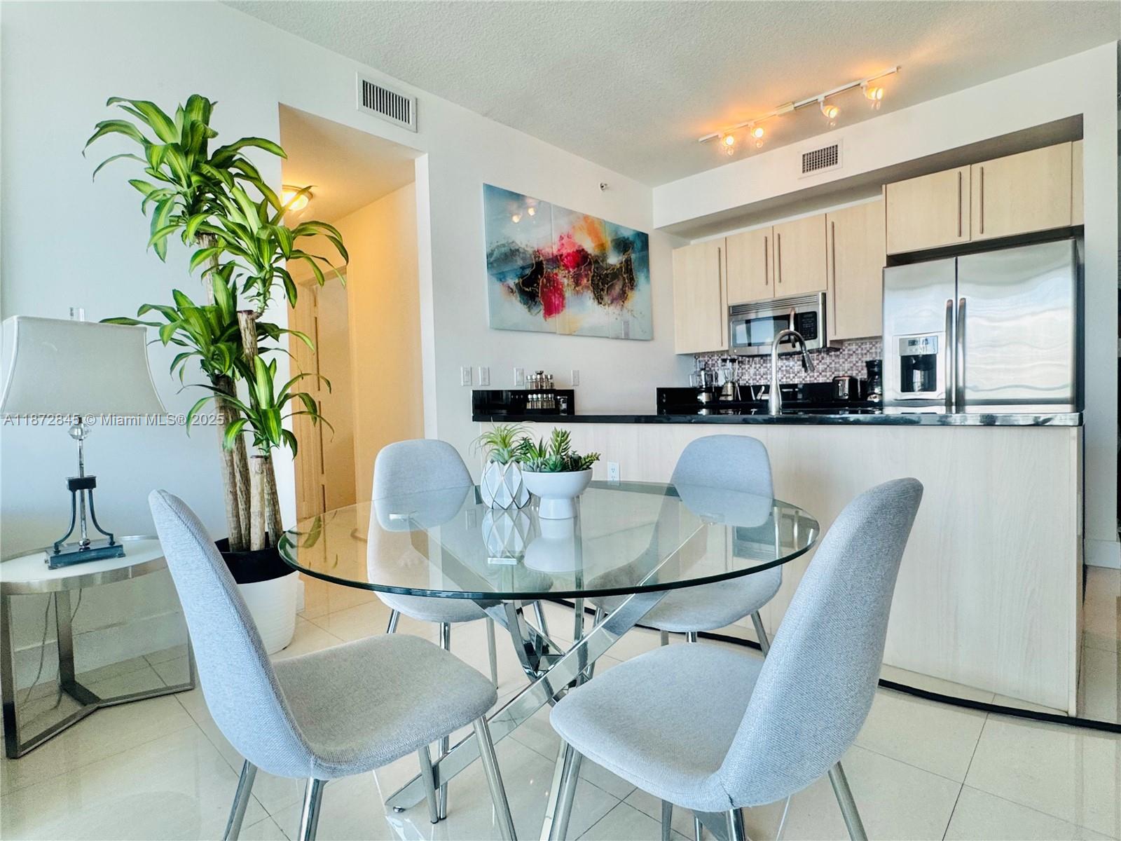 79 Southwest 12th Street, Unit 3211S Miami, FL 33130 - Photo 6 of 32 a dining room with furniture and wooden floor