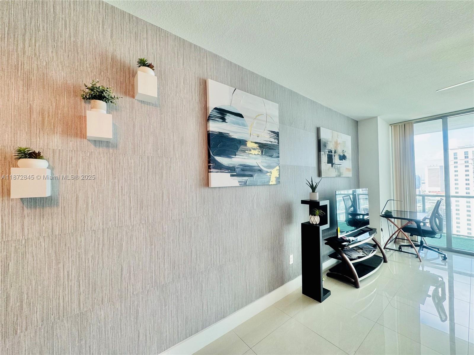 79 Southwest 12th Street, Unit 3211S Miami, FL 33130 - Photo 10 of 32 a view of a livingroom with workspace and a window