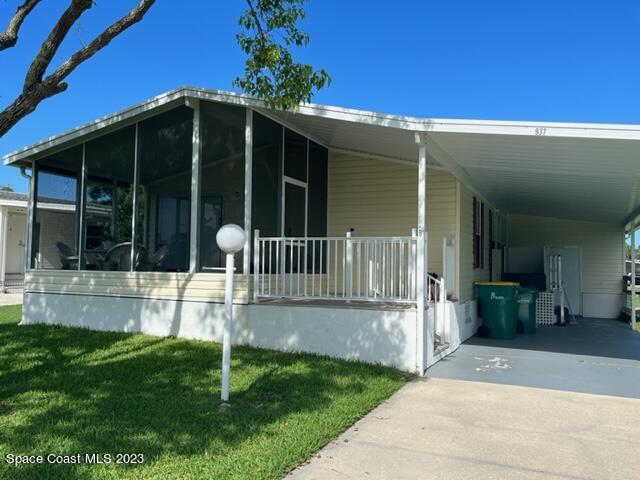 a view of a house with a yard and porch