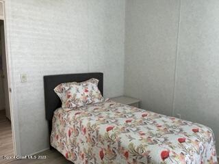 937 Laurel Circle Sebastian, FL 32976 - Photo 14 of 22 a bedroom with a bed and a wooden floor