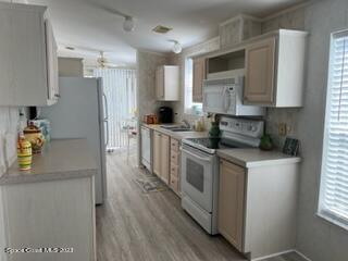 937 Laurel Circle Sebastian, FL 32976 - Photo 4 of 22 a kitchen with stainless steel appliances a stove a sink a refrigerator a counter space and cabinets