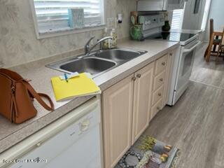 937 Laurel Circle Sebastian, FL 32976 - Photo 5 of 22 a kitchen with stainless steel appliances granite countertop a sink and a white cabinets