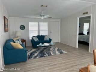 937 Laurel Circle Sebastian, FL 32976 - Photo 9 of 22 a living room with furniture and a chandelier