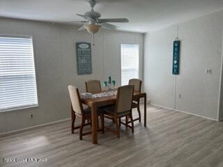 937 Laurel Circle Sebastian, FL 32976 - Photo 10 of 22 a view of a dining room with furniture window and wooden floor