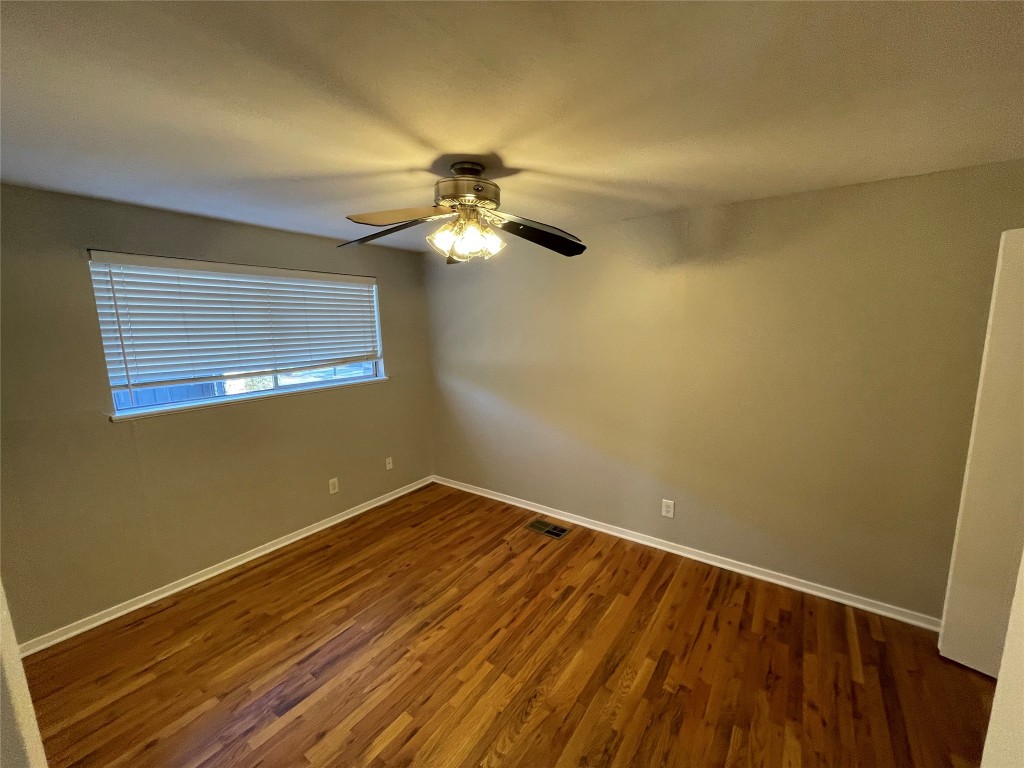 610 Franklin Boulevard, Unit B Austin, TX 78751 - Photo 11 of 14 a view of a room with wooden floor and fan