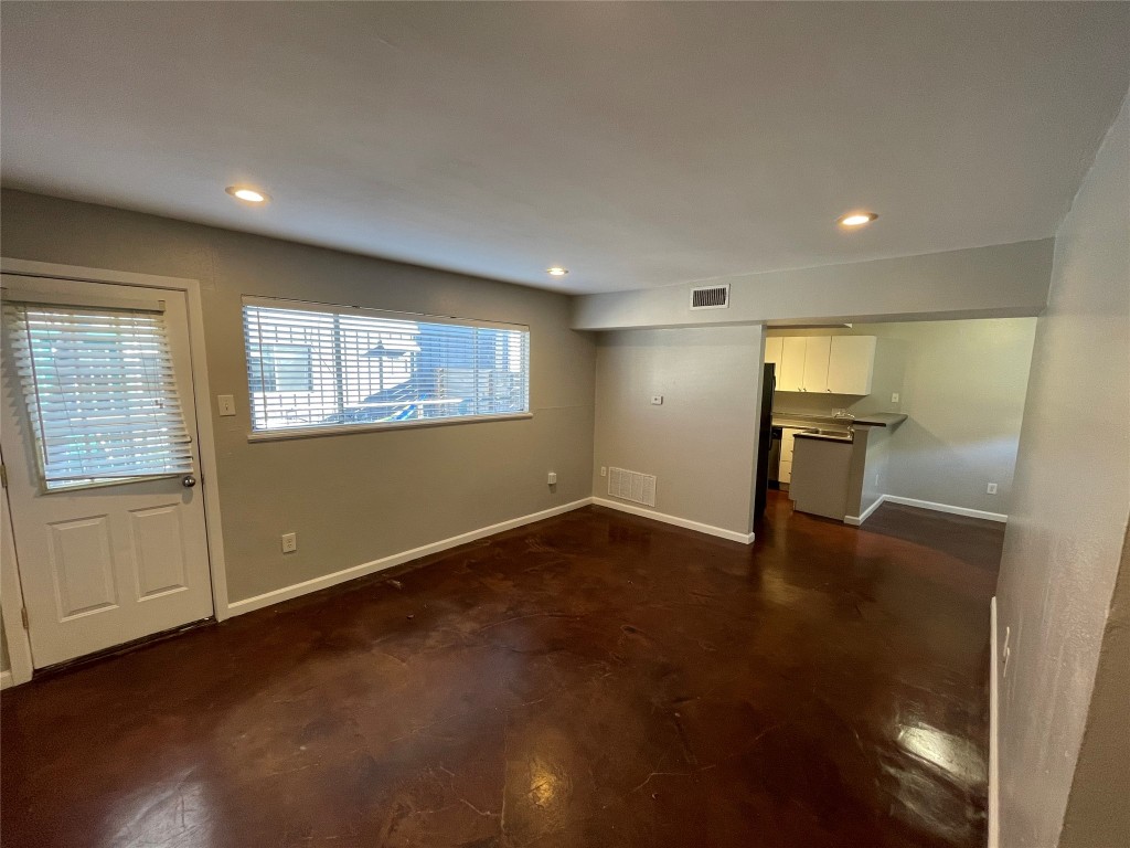 610 Franklin Boulevard, Unit B Austin, TX 78751 - Photo 3 of 14 a view of an empty room with a window and wooden floor