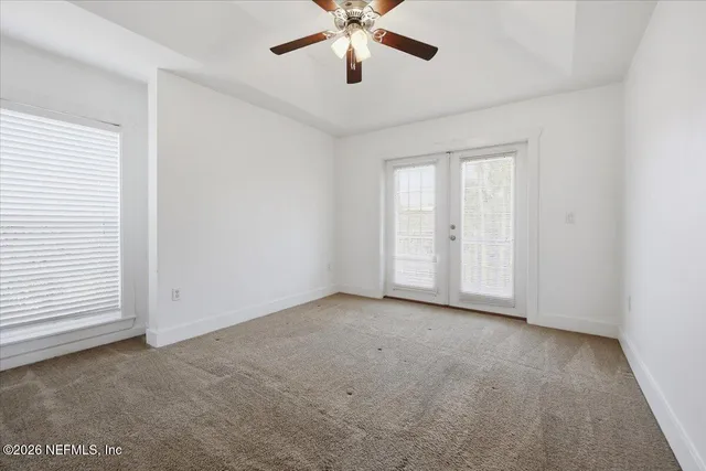 an empty room with closet and windows