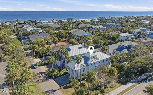 an aerial view of a house with a ocean view