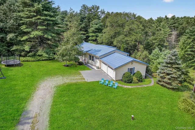 a view of a house with a yard table and a sitting area