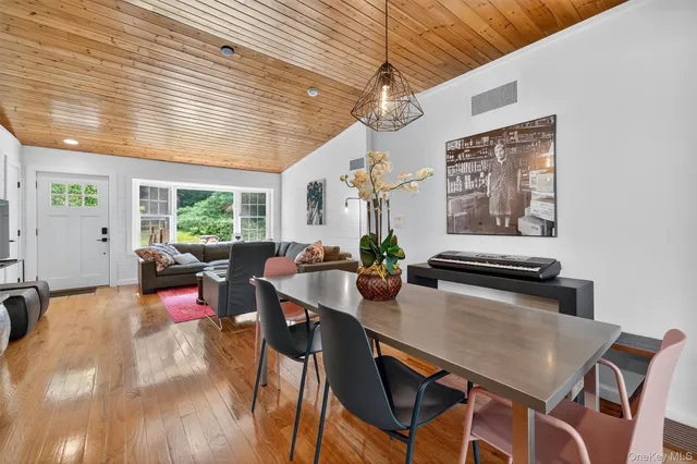 a view of a dining room with furniture window and wooden floor