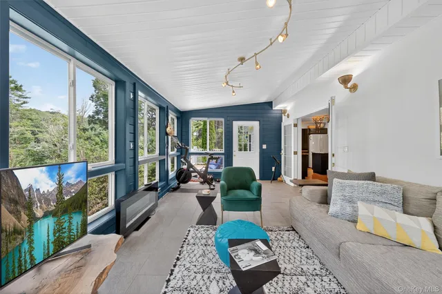 a living room with furniture and a floor to ceiling window