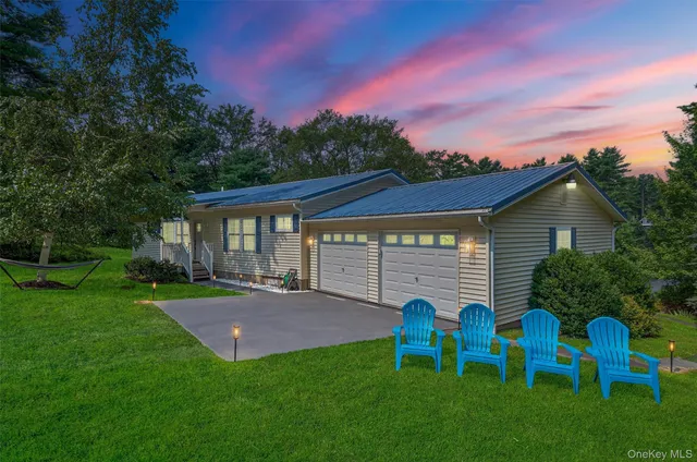 a view of a house with a yard porch and sitting area