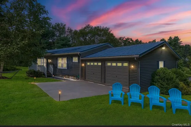 a view of a chair and table in backyard of the house