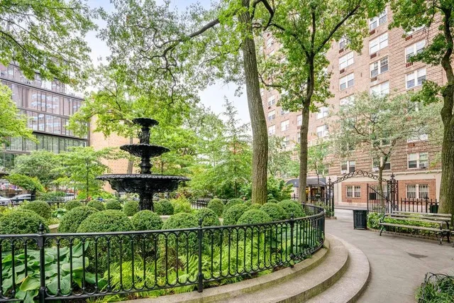 a front view of a building and trees
