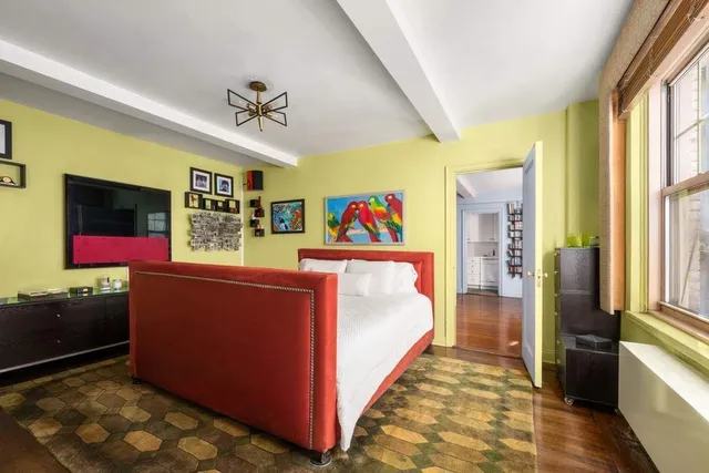 a bedroom with bed and a window