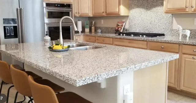 a kitchen with stainless steel appliances granite countertop a stove a sink and a microwave