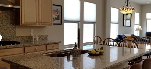 a kitchen with granite countertop a stove and a sink