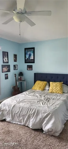 a view of walk in closet with clothes