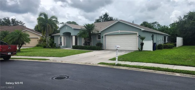 a front view of house with yard and green space