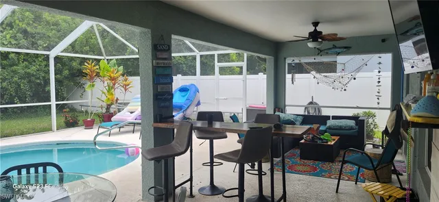 a view of a dining room with furniture one side kitchen view and a window