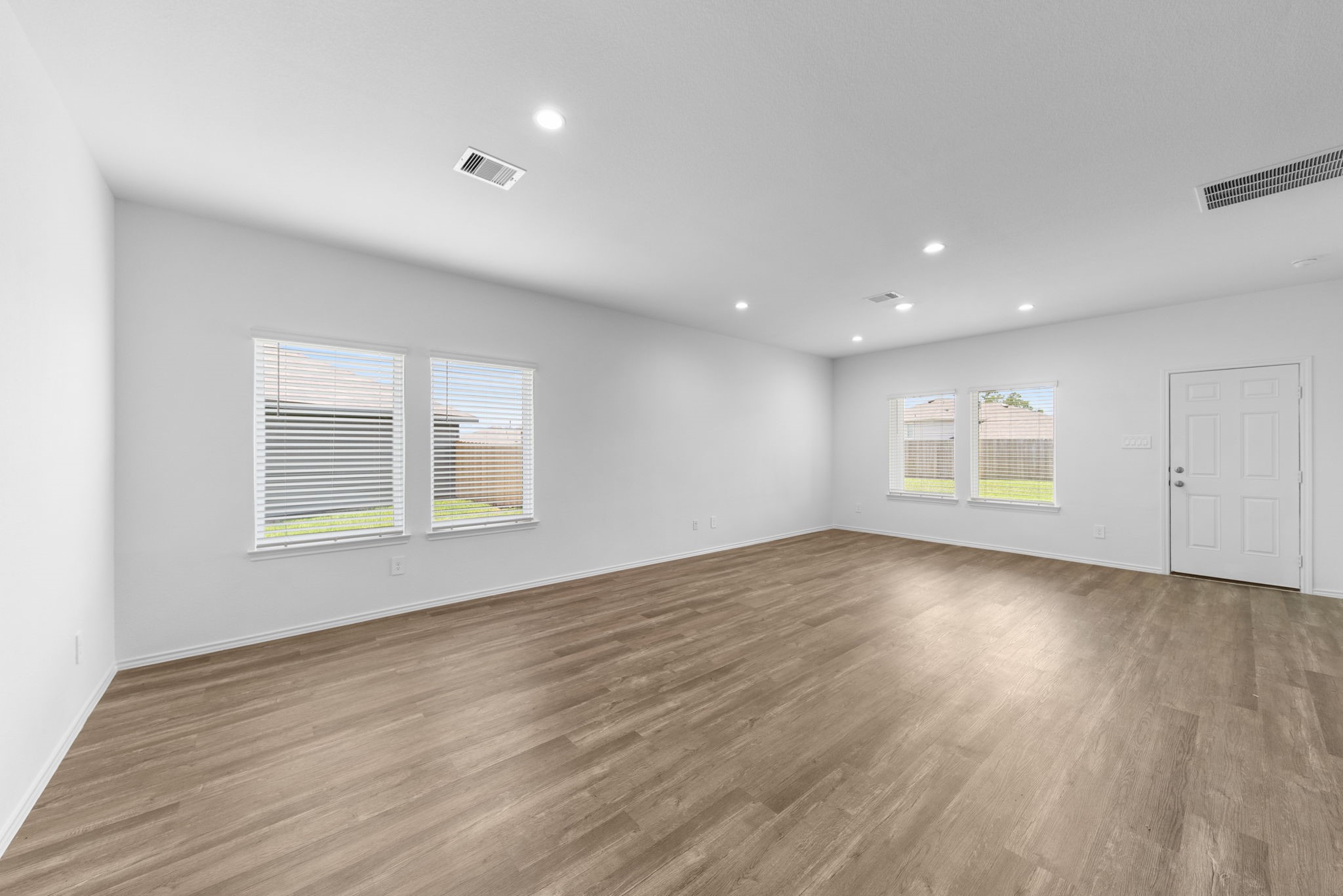 16727 Hemlock Forest Lane Magnolia, TX 77355 - Photo 13 of 35 an empty room with wooden floor and windows