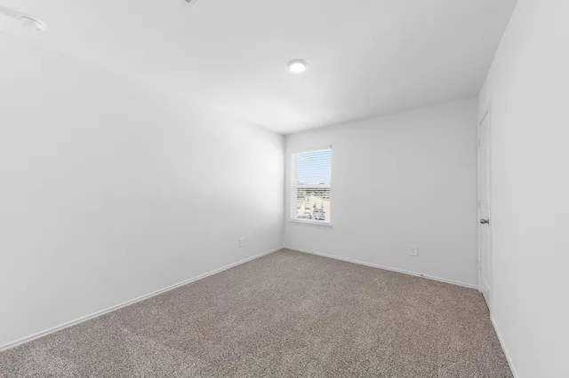 a view of an empty room and a window