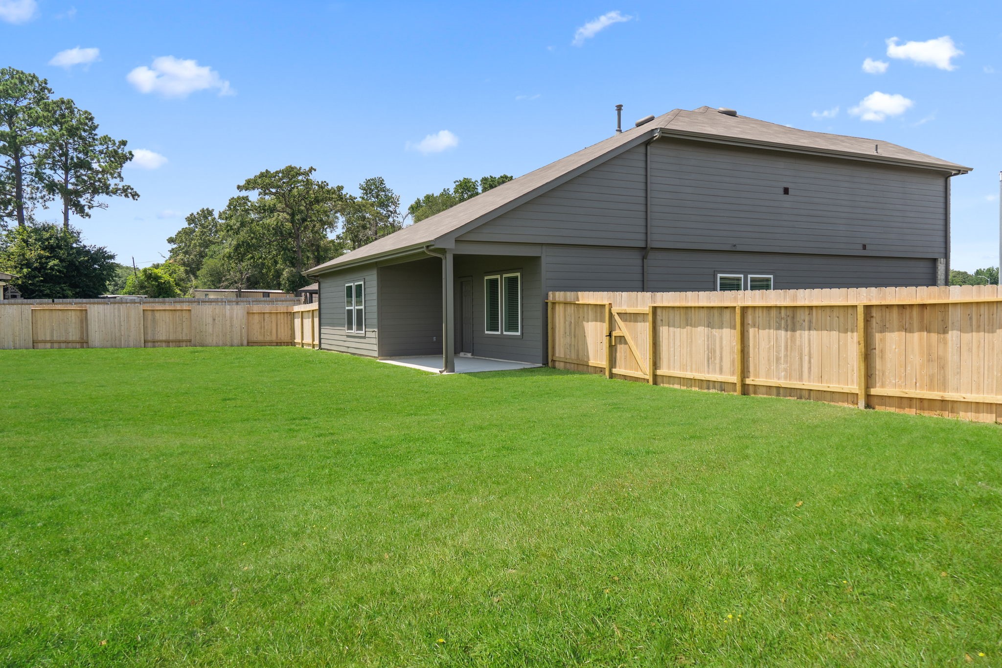 16727 Hemlock Forest Lane Magnolia, TX 77355 - Photo 30 of 35 a backyard of a house with lots of green space