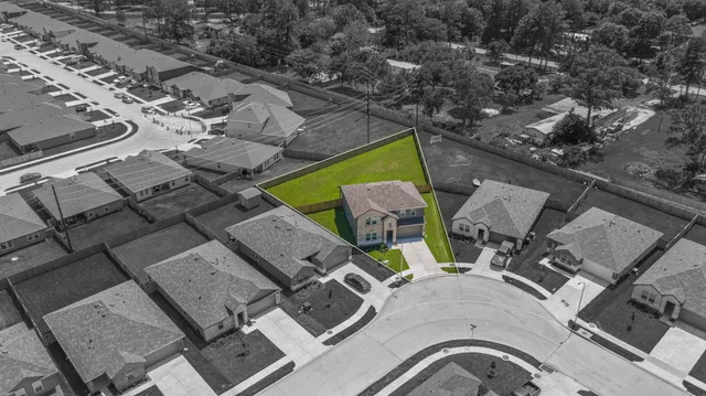 an aerial view of a house with outdoor space