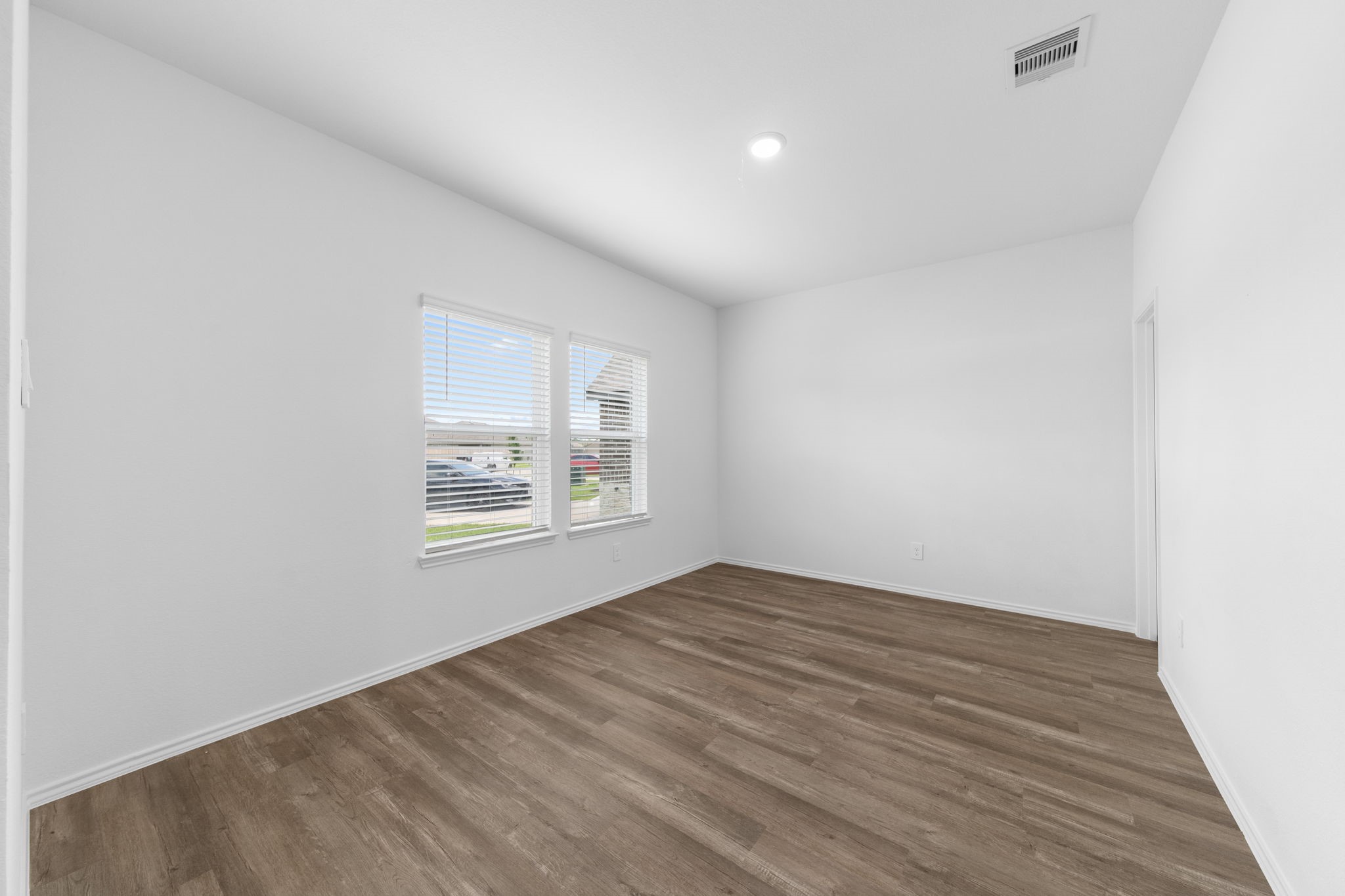 16727 Hemlock Forest Lane Magnolia, TX 77355 - Photo 4 of 35 an empty room with wooden floor and windows