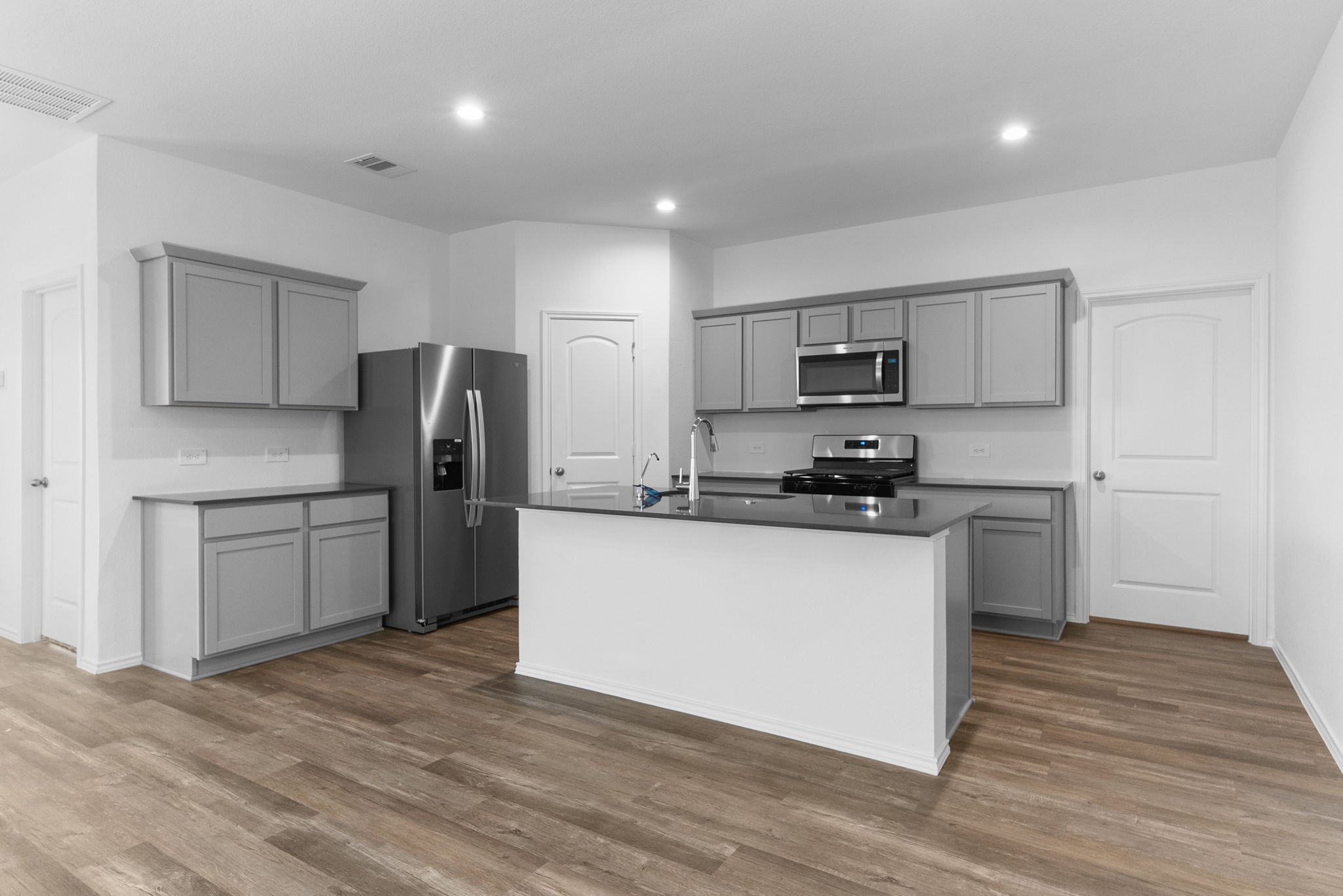 16727 Hemlock Forest Lane Magnolia, TX 77355 - Photo 6 of 35 a kitchen with stainless steel appliances a refrigerator stove microwave and cabinets