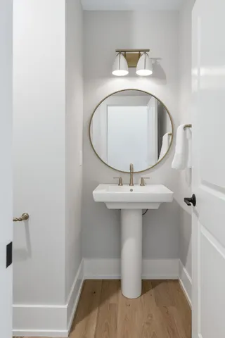 a bathroom with a sink a mirror and vanity