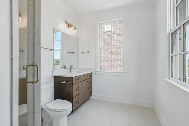 a bathroom with a sink toilet and shower