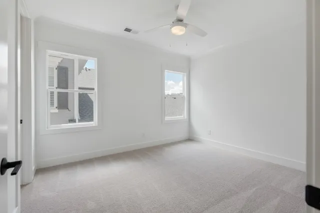 an empty room with windows and closet