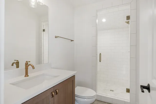 a bathroom with a sink toilet and shower