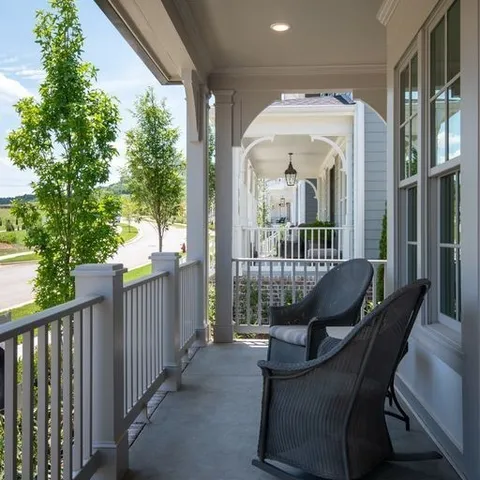a view of a balcony with chair and wooden floor