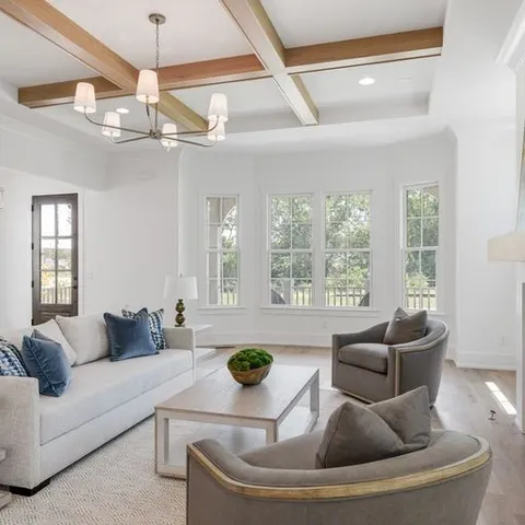 a living room with furniture and a chandelier