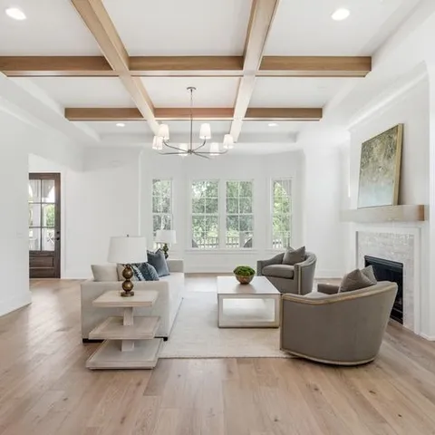 a living room with furniture and a chandelier