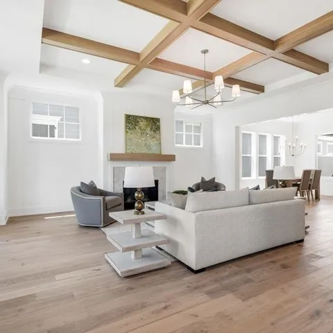 a living room with furniture and a chandelier