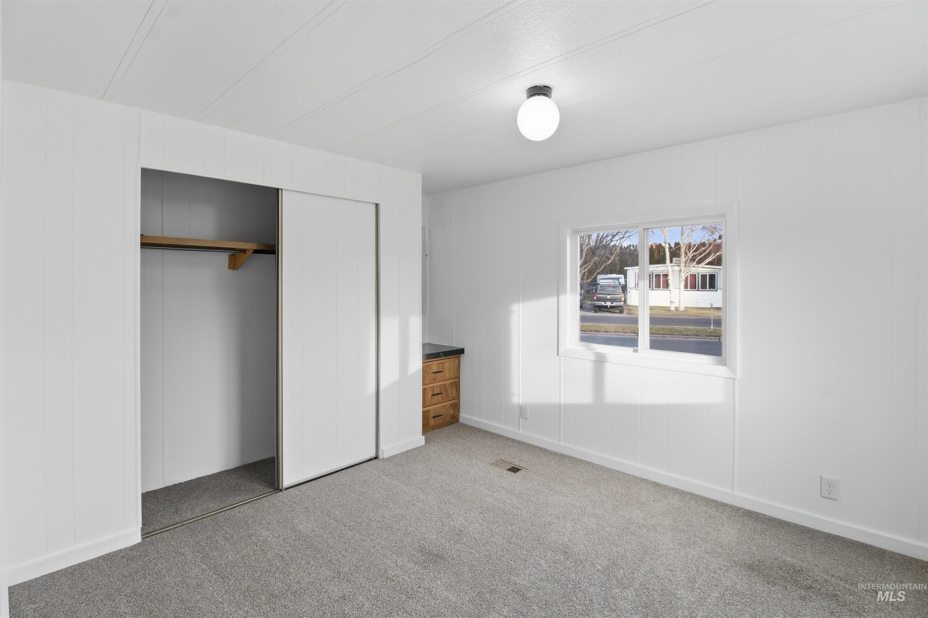 198 South Hills Road, Unit 43 Twin Falls, ID 83301 - Photo 11 of 25 Unfurnished bedroom featuring a closet and light colored carpet