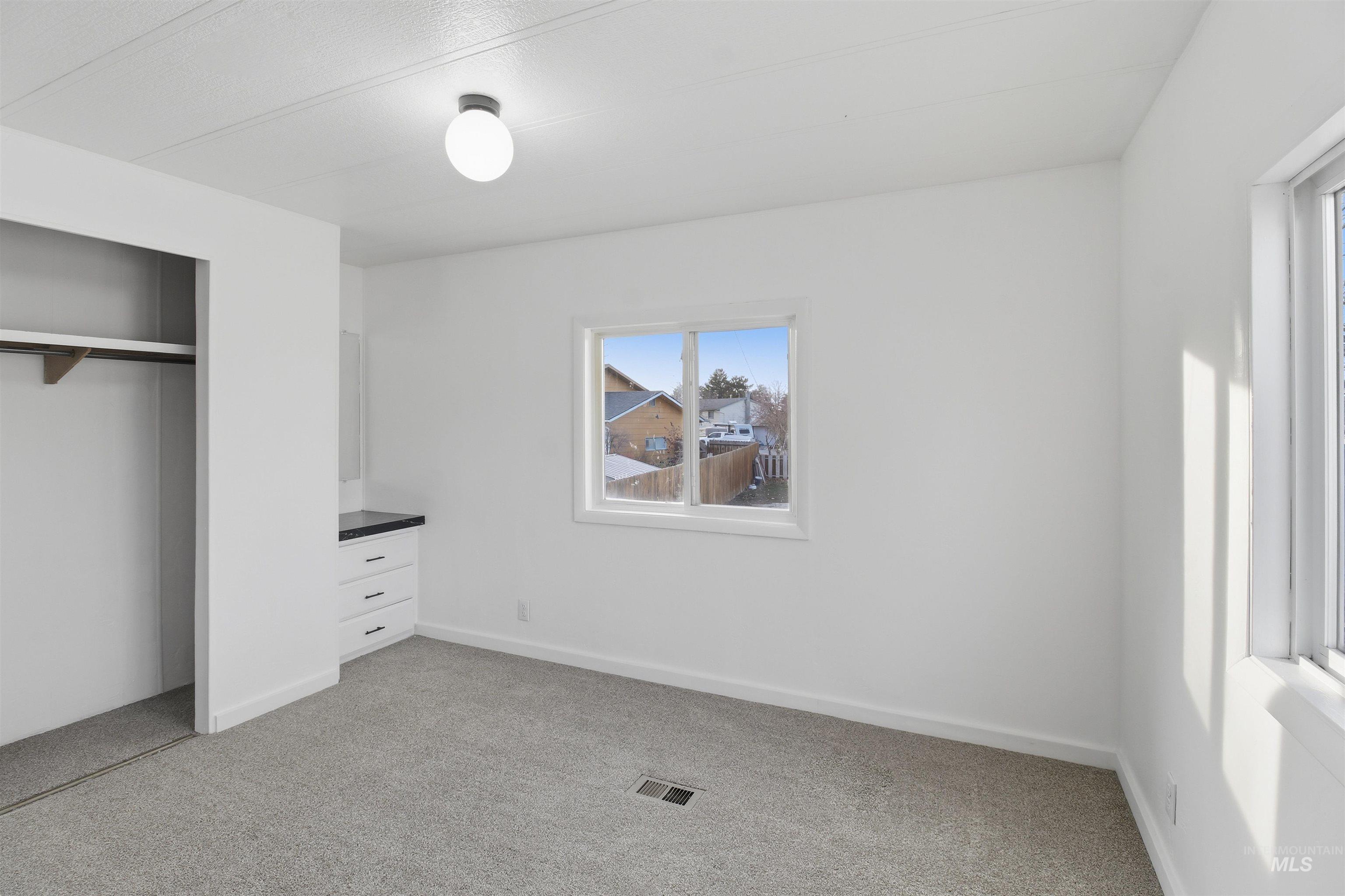 198 South Hills Road, Unit 43 Twin Falls, ID 83301 - Photo 12 of 25 Unfurnished bedroom featuring light colored carpet and a closet