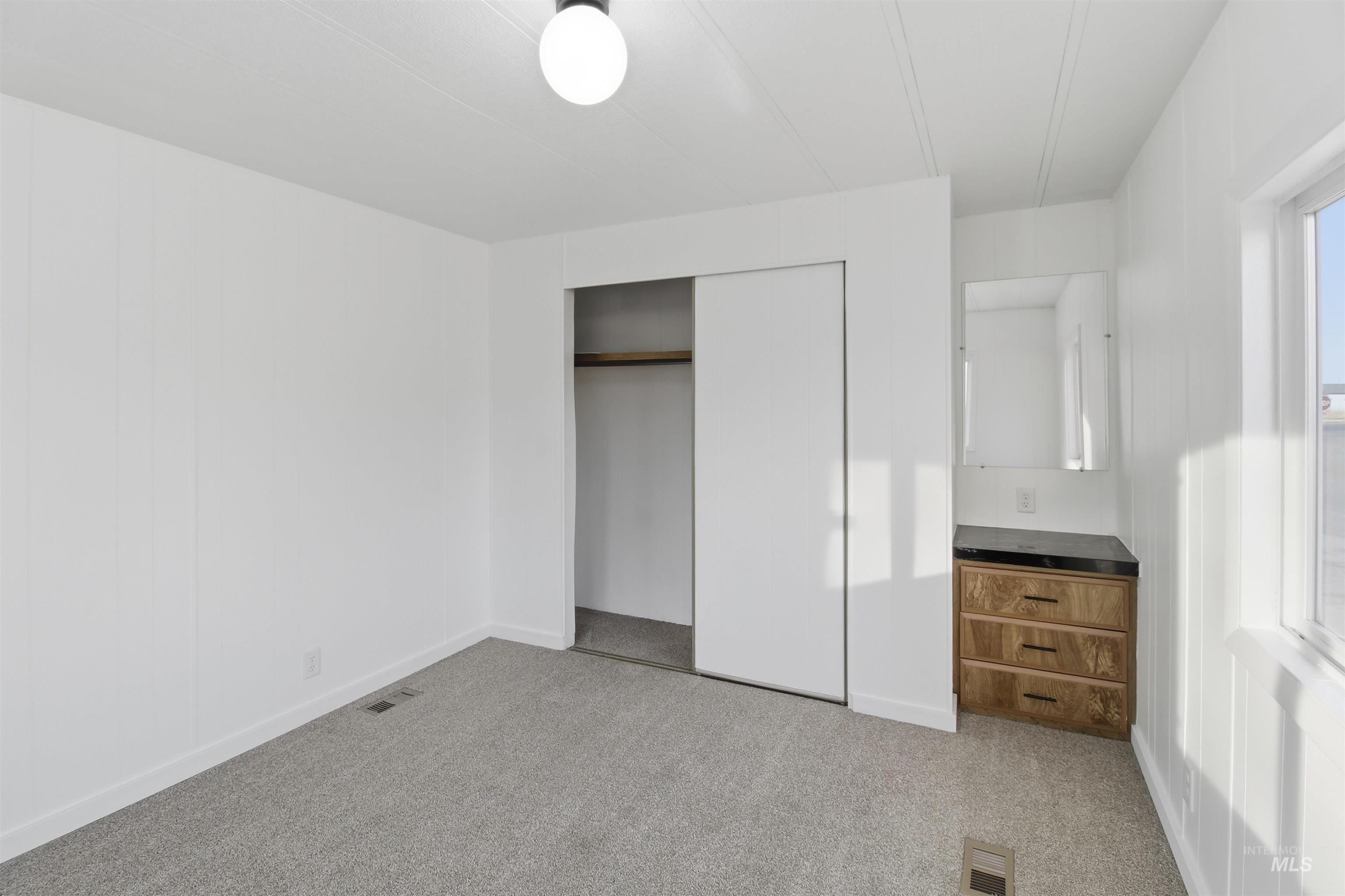 198 South Hills Road, Unit 43 Twin Falls, ID 83301 - Photo 13 of 25 Unfurnished bedroom with light carpet and a closet