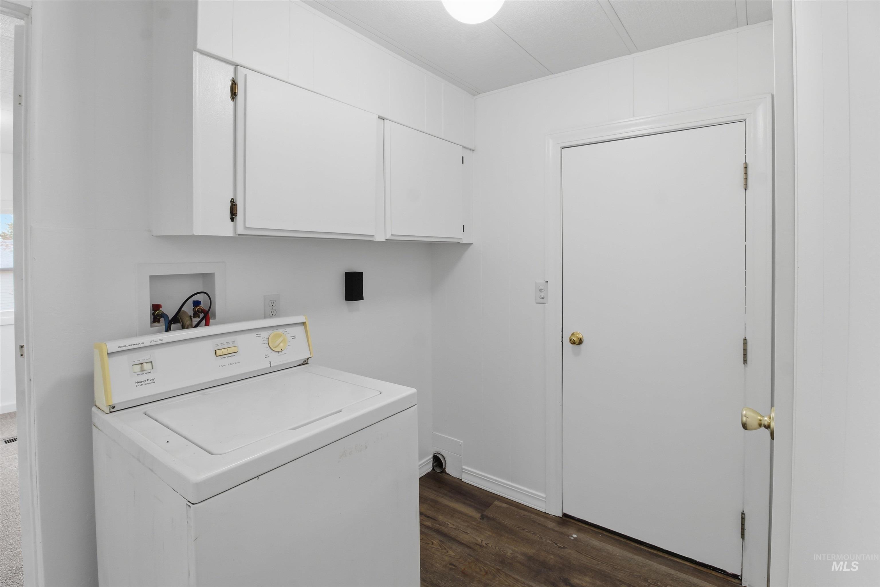 198 South Hills Road, Unit 43 Twin Falls, ID 83301 - Photo 15 of 25 Laundry room featuring washer / dryer, dark wood-type flooring, and cabinet space