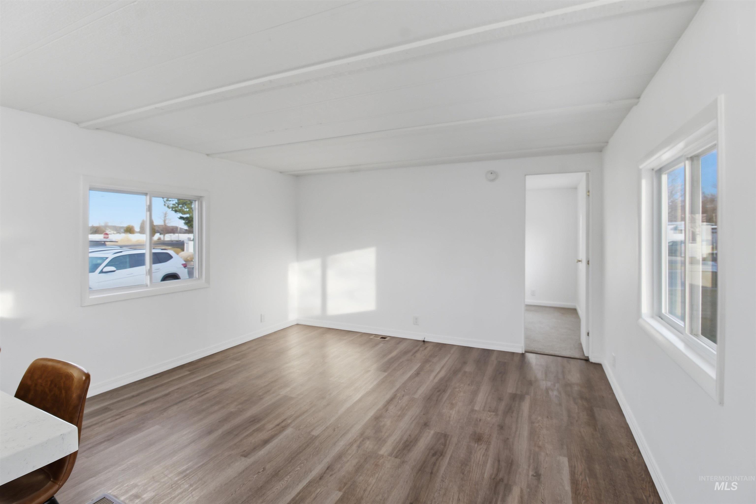 198 South Hills Road, Unit 43 Twin Falls, ID 83301 - Photo 10 of 25 Empty room with dark wood-style floors and baseboards