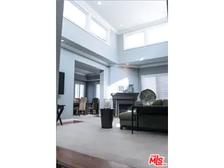 a living room with furniture and a piano